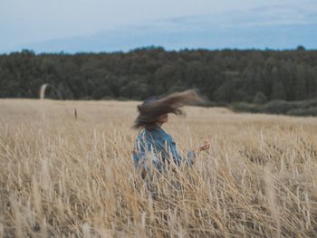 Side view of woman on field