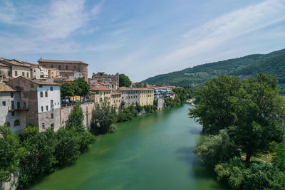 River amidst buildings against sky