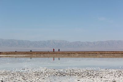 Scenic view of salt flat against sky