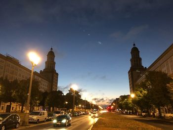 View of city street and buildings at night