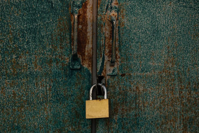 Close-up of padlock on metal door