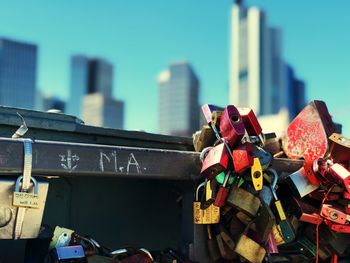 Low angle view of padlocks against buildings in city