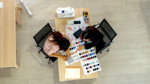 High angle view of woman working with colleague at creative office