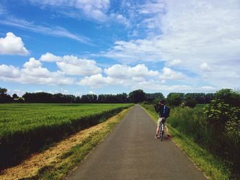 Cyclist taking photo of field