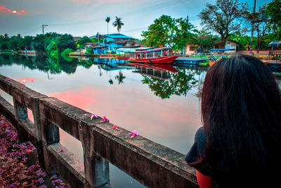 Rear view of woman on boat in lake