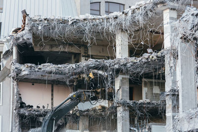 Cropped photo of building demolition excavator. demolition of a building, ruins, reconstruction