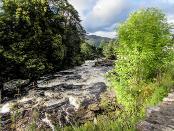 Scenic view of stream against sky