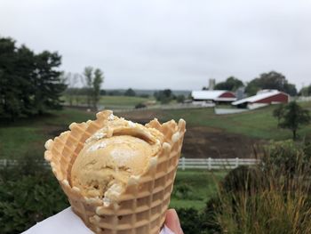 Close-up of hand holding ice cream cone