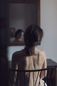 Rear view of woman at home