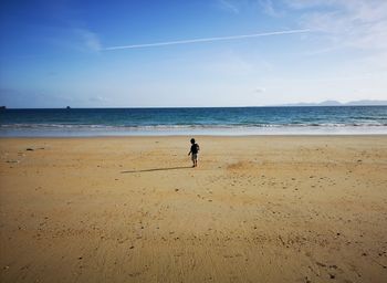 Full length of man on beach against sky