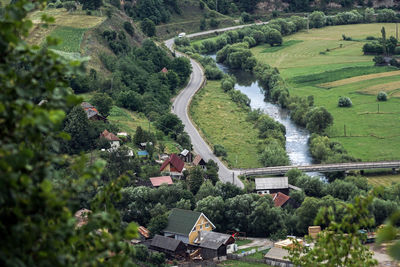 High angle view of houses amidst trees and buildings