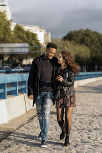 Full length of young couple walking outdoors