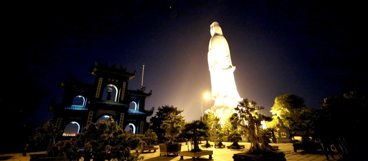 building exterior, built structure, architecture, religion, spirituality, place of worship, clear sky, sun, tree, night, illuminated, copy space, sunlight, sky, glowing, temple - building, outdoors, no people, low angle view