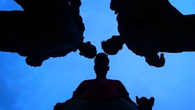 low angle view, blue, silhouette, clear sky, human representation, statue, sky, sculpture, creativity, art and craft, art, person, part of, men, outdoors, copy space, day