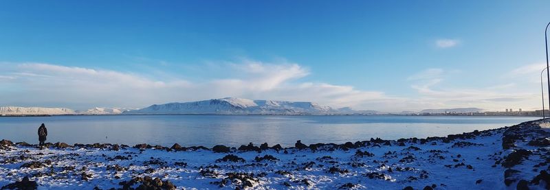 Panoramic view of sea against blue sky