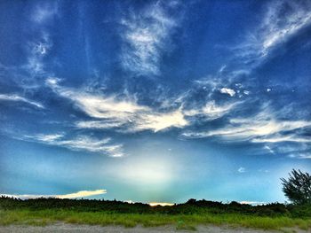 Scenic view of field against blue sky