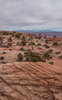 Full frame view of sandstone with snow capped mountains in the background