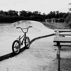 Bicycle by road against sky