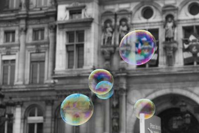 Bubbles against rainbow in city