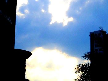 Silhouette of building against cloudy sky