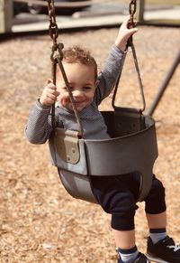 First time on the swing at the playground. 