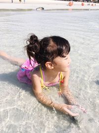 High angle view of girl playing in sea
