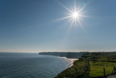 Scenic view of sea against sky on sunny day