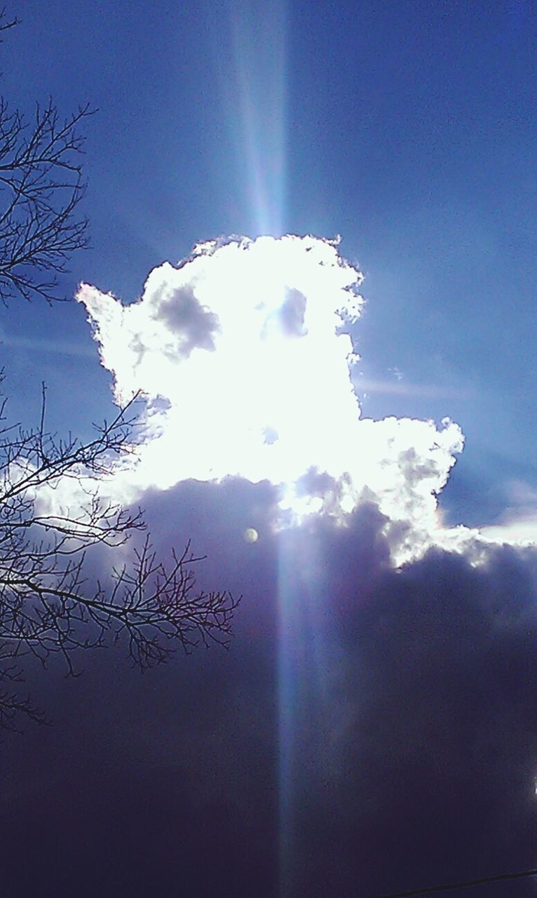 sun, sunbeam, sunlight, lens flare, sky, low angle view, blue, beauty in nature, nature, tranquility, bright, scenics, sunny, tranquil scene, cloud - sky, day, white color, outdoors, no people, idyllic