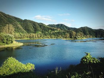 Scenic view of lake and mountains against sky