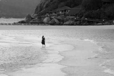 High angle view of woman standing in sea