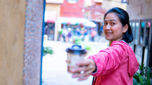 Portrait of smiling woman standing outdoors