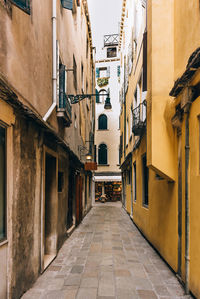 Narrow street amidst buildings in city