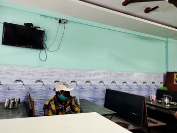 Man working on table by sea