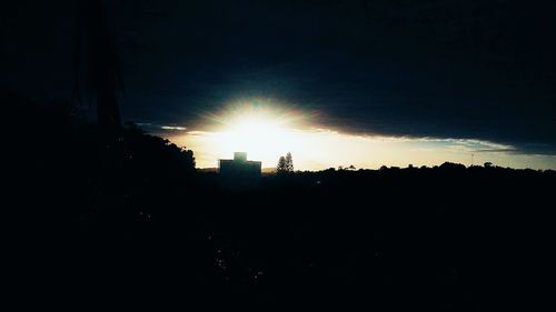 Silhouette buildings against sky during sunset