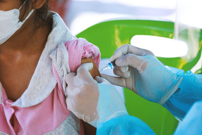 Midsection of doctor examining patient in hospital