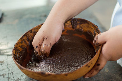 Cropped image of person preparing hot chocolate in bowl