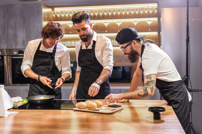 Rear view of people working at restaurant