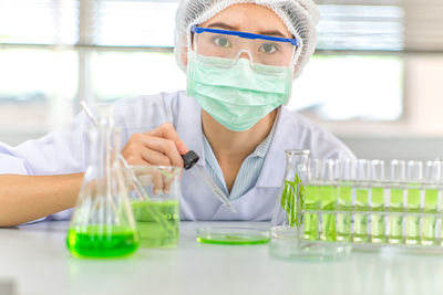 Portrait of female scientist experimenting in laboratory