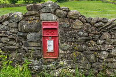Public mailbox on stone wall