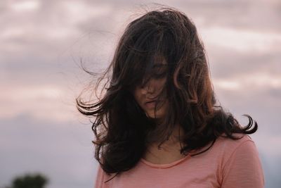 Portrait of teenage girl against sky