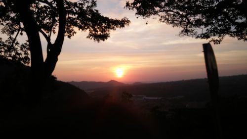 Scenic view of silhouette mountains against sky at sunset