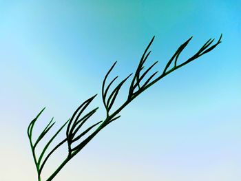 Close-up of stalks against clear blue sky