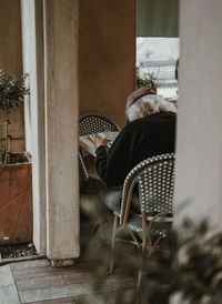 Woman sitting on chair in building