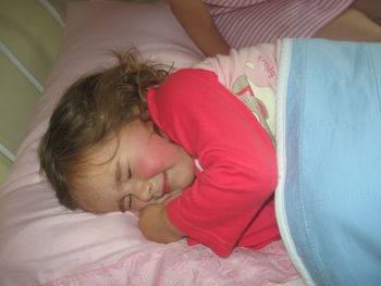 High angle view of baby sleeping on bed