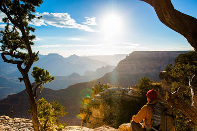 Man sitting against mountains