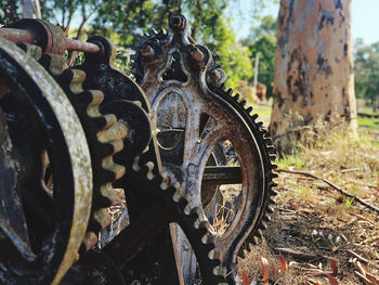 Close-up of old rusty wheel on field