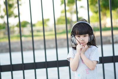 Full length portrait of girl standing outdoors