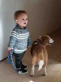 Cute boy with dog at home