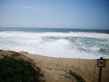 Scenic view of beach against clear sky