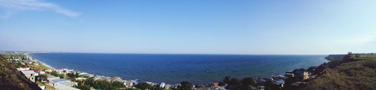 sea, horizon over water, water, beach, scenics, shore, beauty in nature, tranquil scene, sky, tranquility, clear sky, nature, blue, copy space, large group of people, coastline, high angle view, panoramic, vacations, idyllic